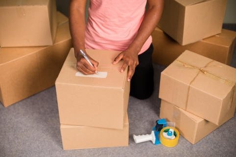 Woman packing up boxes with tape